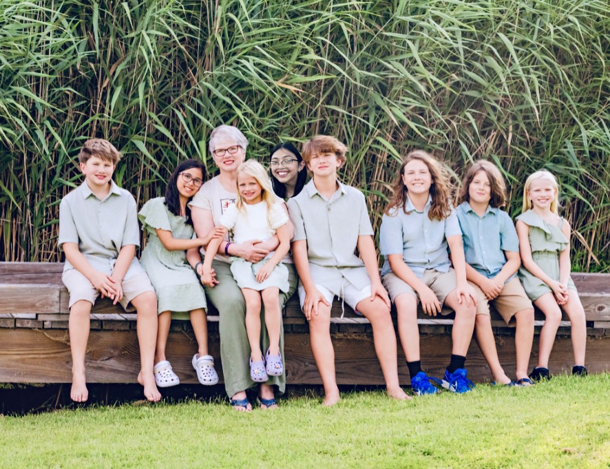 Carolyn and her grandchildren are at the beach in North Carolina July 2025.